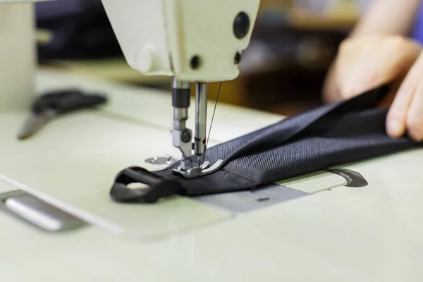 Woman sewing bag detail