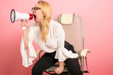 caucasian blonde woman in white blouse holds a megaphone, talking at it clipart