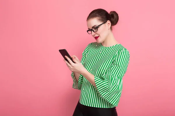 Beautiful Young Woman Stylish Eyeglasses Using Smartphone Pink Studio Background — Stock Photo, Image
