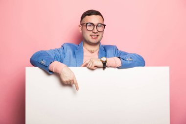 Boş afişini işaret eden yakışıklı genç 