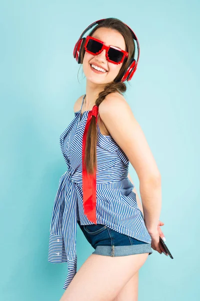 Ładna Brunetka Dziewczyna Nowoczesne Słuchawki Trzymając Smartfon Jej Plecami — Zdjęcie stockowe