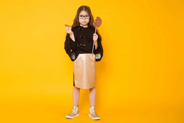 Linda Niña Morena Sosteniendo Caramelos Piruleta Sobre Fondo Amarillo — Foto de Stock