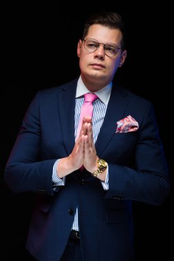 Yakışıklı delikanlı agaist karanlık studio arka plan yalvarıyor 