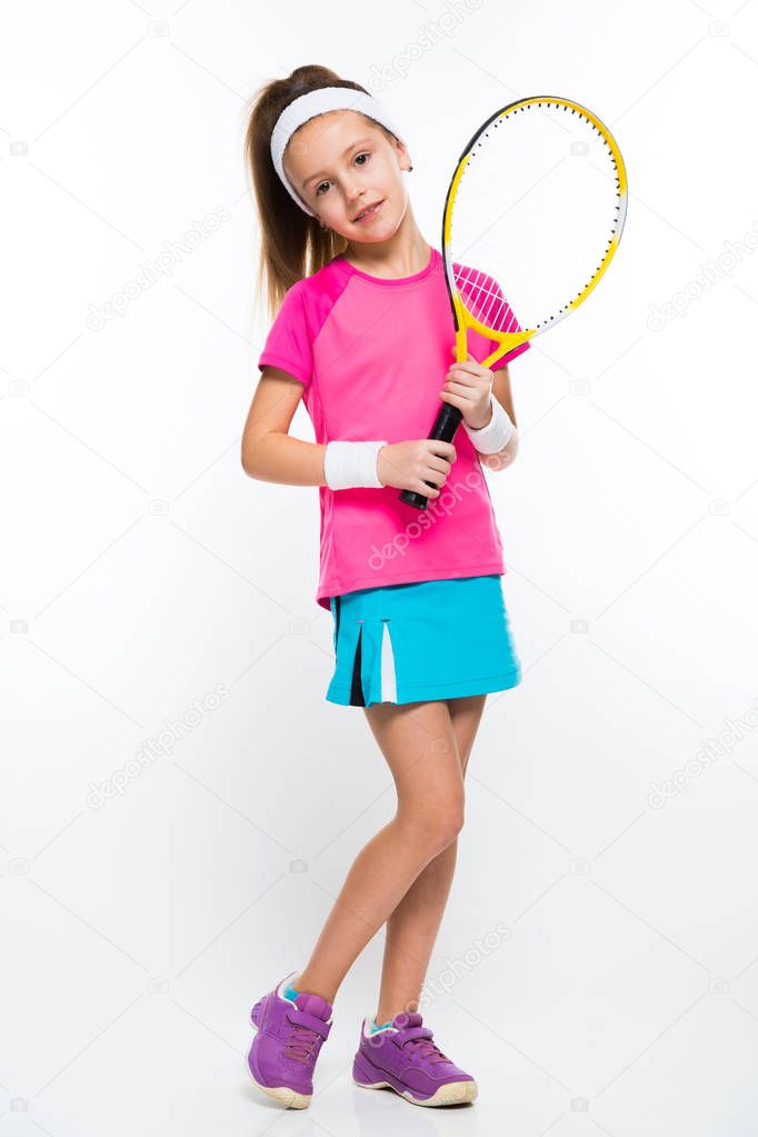 Cute little girl with squash racket smiling at camera 