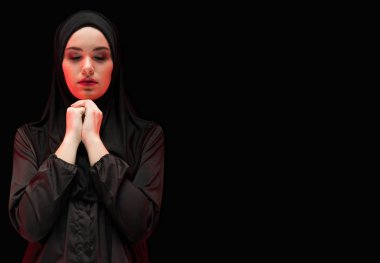 Geleneksel giysiler içinde dua eden genç Müslüman kadın portresi