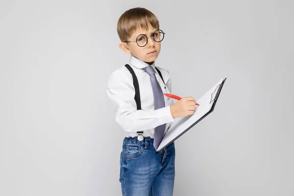 Portrait Adorable Serious Confident Little Boy Glasses Holding Clipboard Grey — Stock Photo, Image