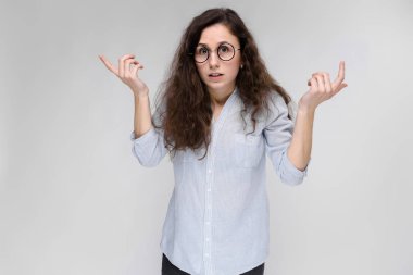 Çekici genç kıvırcık esmer beyaz kadın gri izole gözlük