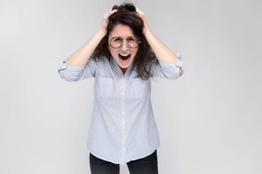 Genç esmer kıvırcık Kafkas bardaklarda gri izole kadın bağırıyor