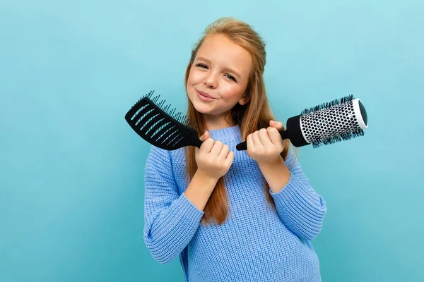 Little Girl Posing Two Hairbrushes Blue Background — Zdjęcie stockowe