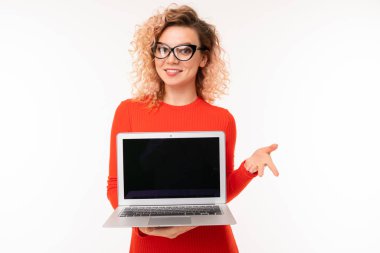 young woman in red dress posing with laptop against white background  