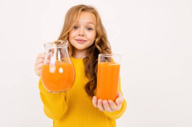 Stüdyoda hafif arka planda meyve suyu ile poz veren tatlı kız. 