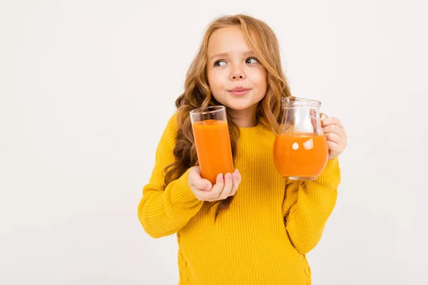cute girl posing with juice in studio on light background