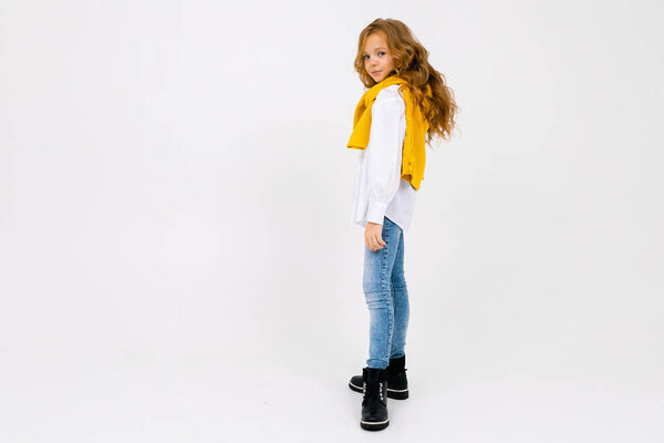 fashionable schoolgirl posing in studio on light background 