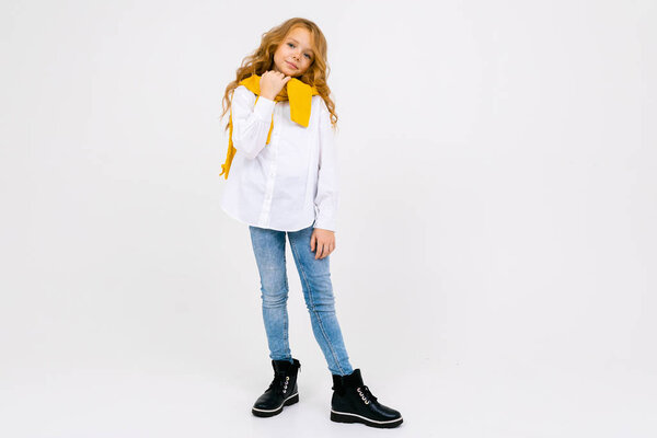 fashionable schoolgirl posing in studio on light background 