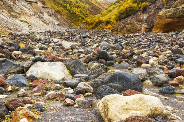 Mountain dry stream (riverbed) by an autumn surrounded by stones and rocks.