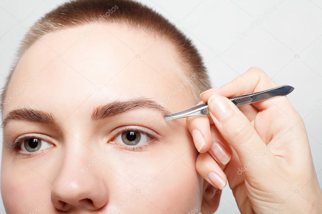 Young woman with short hair plucking