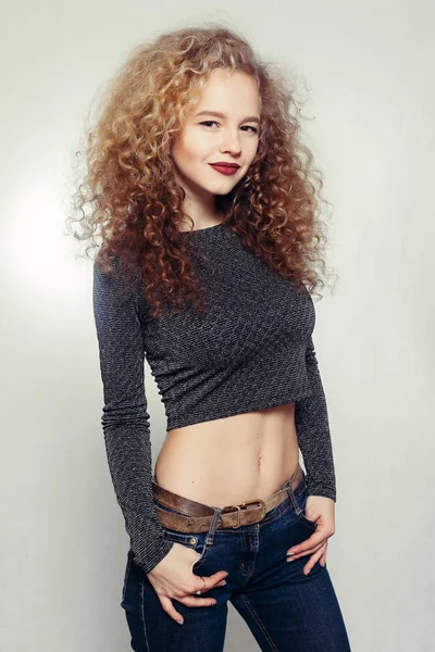 Beauty young woman with curly big and long hair.