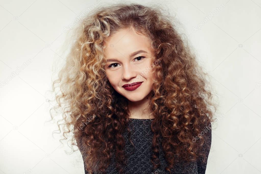 Beauty young woman with curly big and long hair.