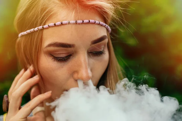Happy vaping young white blonde girl