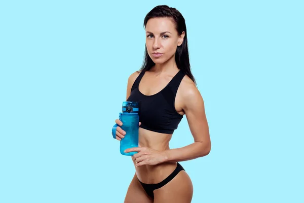 Vista frontal da magro fitness mulher água potável . — Fotografia de Stock