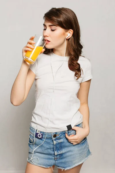Woman juice glass . Female model hold orange juice glass