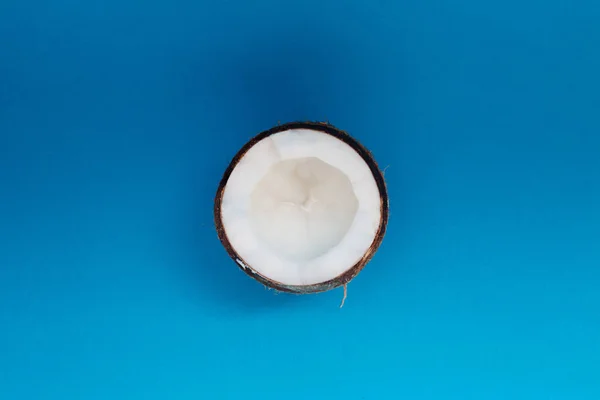 Половина кокосового ореха изолированы на синем фоне. Обрезание пути — стоковое фото