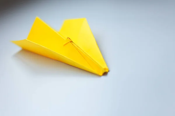 Yellow origami plane on a white background. — Stock Photo, Image