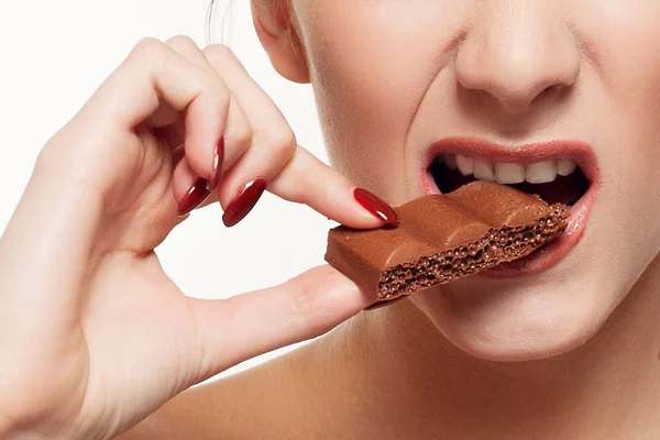 Lovely smiling teenage girl eating chocolate Stock Photo