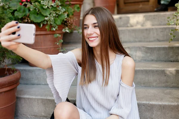 Молодая красотка делает селфи для самодельного смартфона — стоковое фото