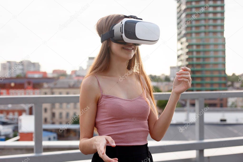 amazed young beautiful girl using new VR technology