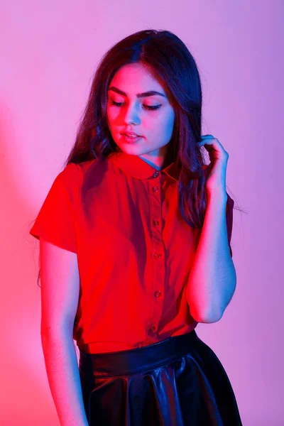 Mujer posando con falda de cuero y camisa roja — Foto de Stock