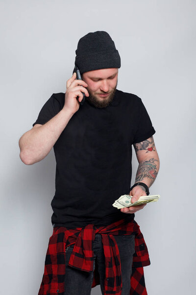 Young man throws money to camera.