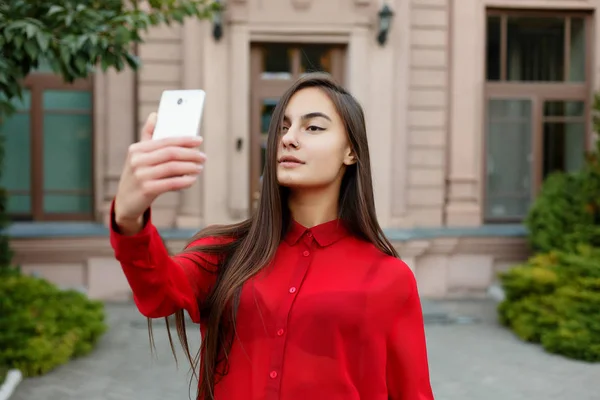 Selfie を作るスタイリッシュな服の若い魅力的な女性の肖像画 — ストック写真