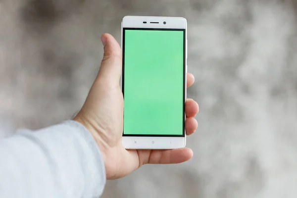 Closeup man hand holding and touching phone with green screen vertical — Stock Photo, Image