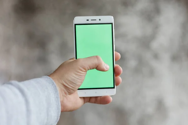 Closeup man hand holding and touching phone with green screen vertical — Stock Photo, Image