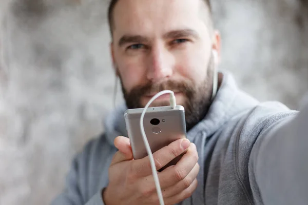 man in studio puts ear phones out to music.