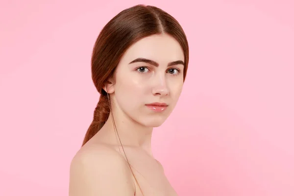 Beautiful young girl touching her perfect skin on pink background. — 스톡 사진