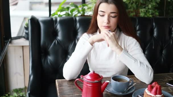 在咖啡馆里用漂亮女人的小玩意做的早茶 紧贴着漂亮的女性笑脸 用杯子喝着热饮料 微笑的女人在咖啡馆喝咖啡或喝茶时有着积极的情绪 — 图库视频影像