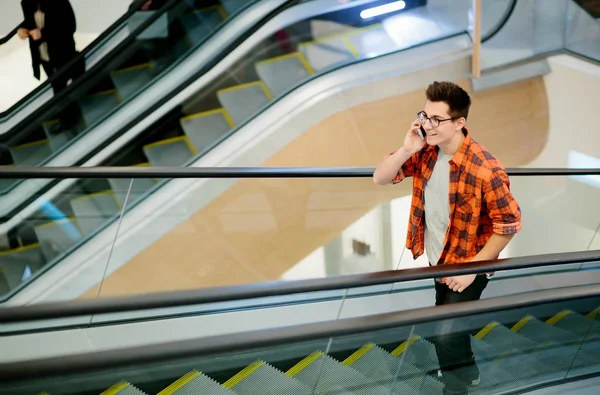 Uomo tenere lo smartphone su sfondo centro commerciale — Foto Stock