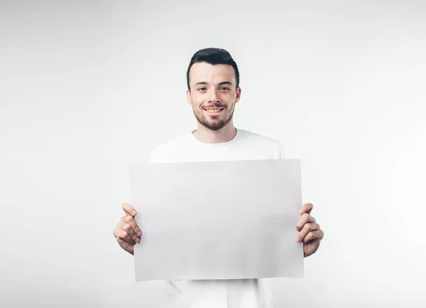 Isolated on white background man holds a poster bearded — Stock Photo, Image
