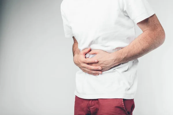 Concepto. Vientre duele contra fondo blanco — Foto de Stock