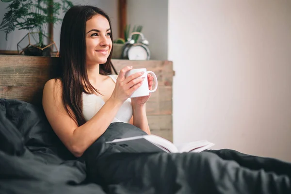 Good morning Woman woke up in bed. Woman drinking coffee in bed