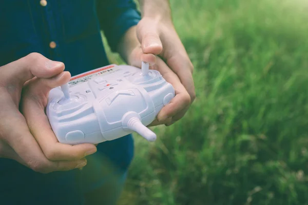 Date on the nature. Leisure for two. Birthday gift. A man and a woman launch a radio-controlled aircraft or a drone or a helicopter into the sky. And they run it together