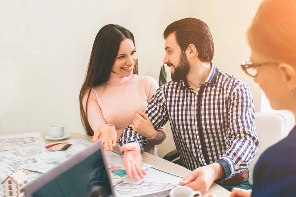 Familia joven pareja compra propiedades de alquiler de bienes raíces. Agente dando consulta a hombres y mujeres. Firma del contrato para la compra de casa o piso o apartamentos. Dando llaves a un par de clientes . — Foto de Stock