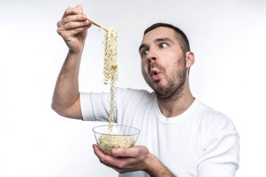 He adores to eat every junk food in a world. Especially he likes to eat food from oriental cuisine. Young man cant wait to eat it. Isolated on white background. clipart