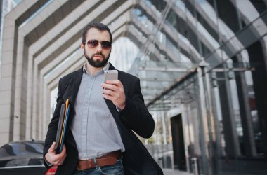 Meşgul bir adam acelesi var, o zaman yok, üstünde belgili tanımlık gitmek telefonda konuşacak. İşadamı birden fazla görev yapıyor. Çoklu görev iş kişi.