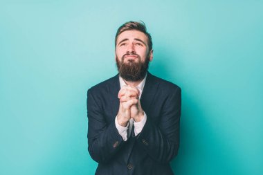 Suite garip adam onun elleri birlikte ad ararken tutuyor. O dua ve onun Tanrı yalvarıyor. Üzerinde mavi arka plan izole.