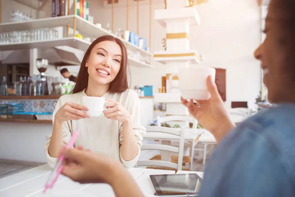 Chicas hermosas y atractivas están tomando un poco de té. Están pasando un tiempo sin estudiar juntos. Están disfrutando de compañía unos de otros. . — Foto de Stock