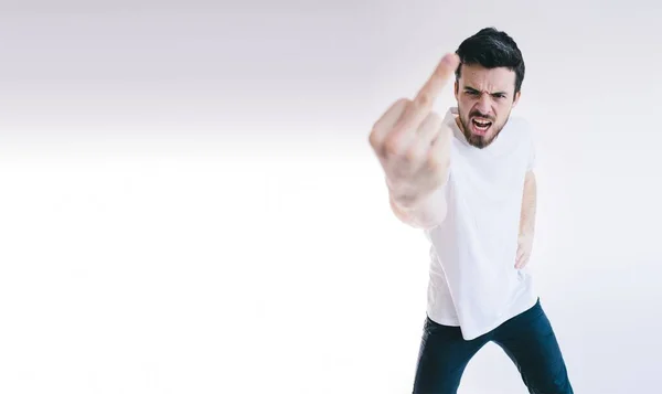 Angry young business man showing fingers at the camera. — Stock Photo, Image