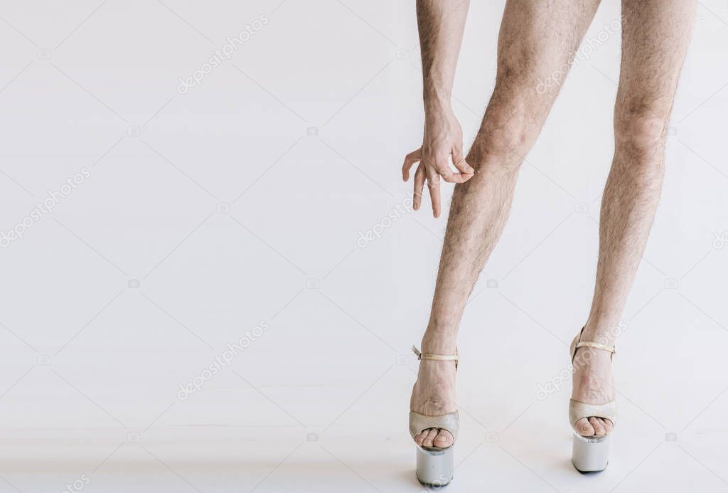 Hairy legs in high heels in pink panties isolated on white background